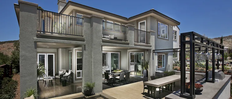 Two-storey Southern California home with replacement windows and a glass patio door system overlooking the pool deck